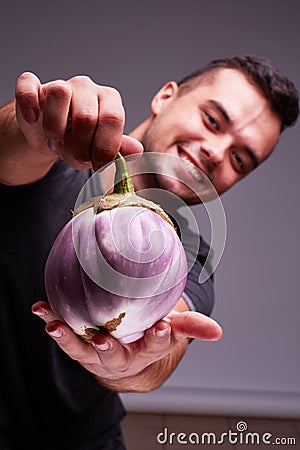 Big beautiful eggplant in man`s hands. Healthy lifestyle. Stock Photo