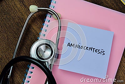 Concept of Amniocentesis write on sticky notes with stethoscope isolated on Wooden Table Stock Photo