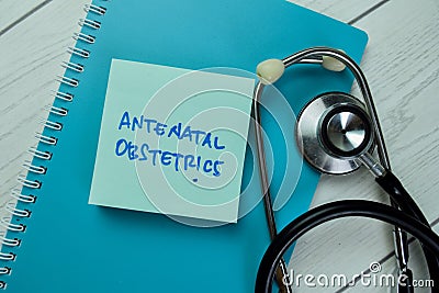 Concept of Antenatal Obstetrics write on sticky notes with stethoscope isolated on Wooden Table Stock Photo