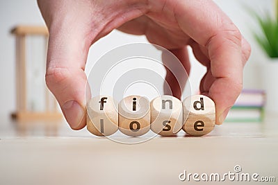 Concept of antonym find and lose on wooden blocks Stock Photo
