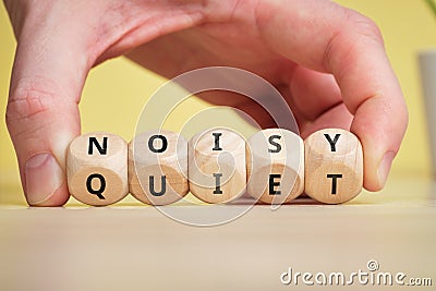 Concept of antonym noisy and quiet on wooden blocks Stock Photo