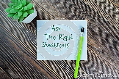 Concept of Ask The Right Questions write on sticky notes isolated on Wooden Table Stock Photo