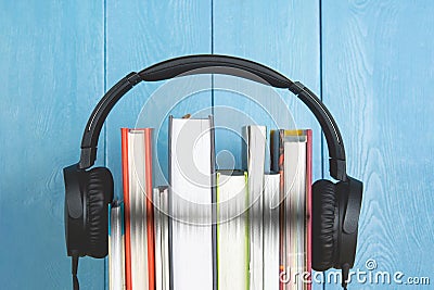 Concept of audio book. headphone and books on blue background Stock Photo