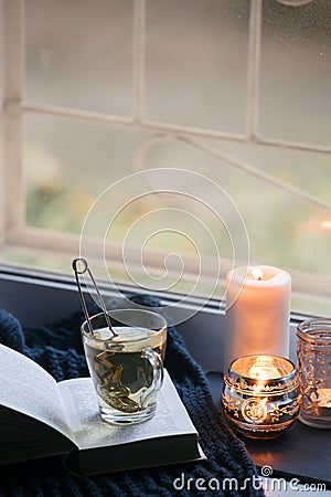 Concept of autumn reading time and romantic, hygge, unplug, mindfulness, Warm, cozy seat opened book, rustic style home decor - Stock Photo