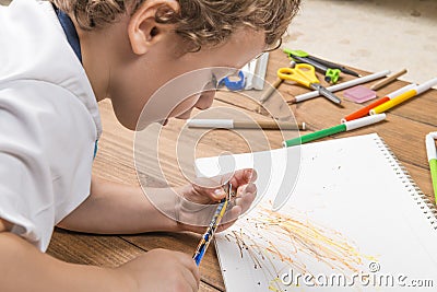 Child sharpening a pencil. Stock Photo