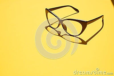 Concept background of black glasses floating above the yellow sp Stock Photo