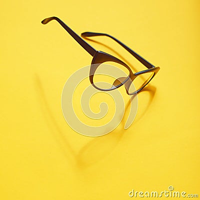 Concept background of black glasses floating above the yellow sp Stock Photo
