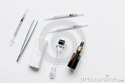 Concept beautician desktop with mezoroller top view on white background Stock Photo