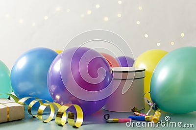 Concept of birthday party.Colorfil baloon, gifts on the table agaisnt bokeh lights Stock Photo