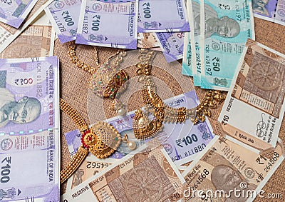 Concept of black money, IT raid, confiscated or unaccounted Money showing Indian currency notes with jewelry Stock Photo