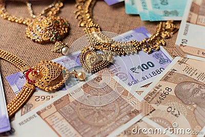 Concept of black money, IT raid, confiscated or unaccounted Money showing Indian currency notes with jewelry Stock Photo