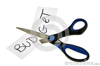 Scissors cutting the word budget with scissors on a white background Stock Photo