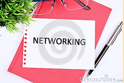 The concept of business and development. Conceptual text, phrase, word NETWORKING on a white sheet of paper, top view Stock Photo