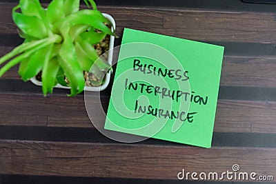 Concept of Business Interruption Insurance write on sticky notes on Wooden Table Stock Photo