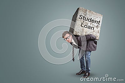 Businessman bending under a heavy stone with the words `Student Loan` written on it Stock Photo