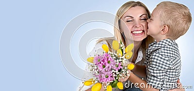 Son gives his beloved mother a beautiful bouquet of tulips.The concept of the celebration,women`s day. Stock Photo