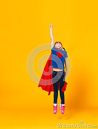 Concept of child superhero costume on yellow background Stock Photo