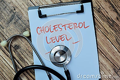 Concept of Cholesterol Level write on paperwork with stethoscope isolated on Wooden Table Stock Photo