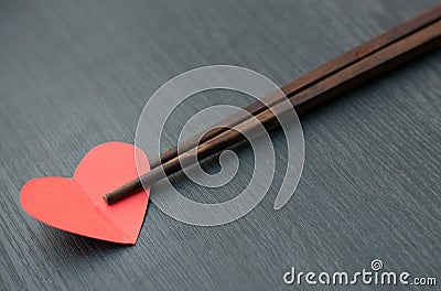 Concept, Chopsticks take a heart like some food. Stock Photo