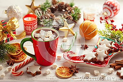 Concept Christmas homemade food and drink. Hot chocolate with marshmallows and cinnamon in red cup, Christmas cookies, winter Stock Photo