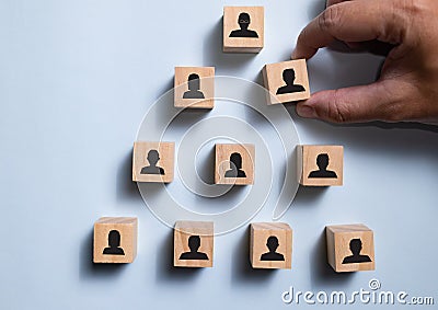 Top view wooden blocks set to organization chart with people icon. Stock Photo