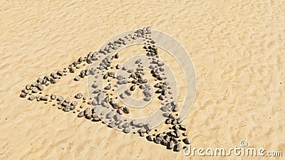 Stones on beach sand handmade symbol shape, golden sandy background, toxic icon Cartoon Illustration