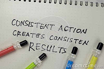 Concept of Consistent Action Creates Consistent Results write on a book isolated on Wooden Table Stock Photo