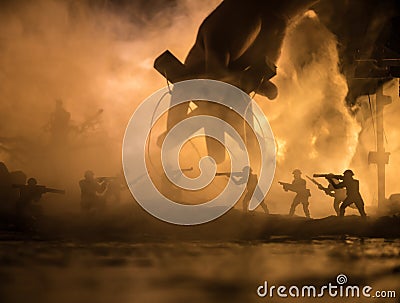 Concept of control. Marionette in human hand. Image on white. Night battle scene. Military fighting silhouettes in destroyed city Stock Photo