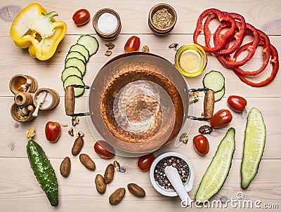 Concept cooking salad of various spices and herbs vegetables, laid out around copper bowls for salad , place for text Stock Photo