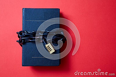 Concept for copyright, patent or intellectual property and idea protection. Book wrapped in a chain with a lock. Stock Photo