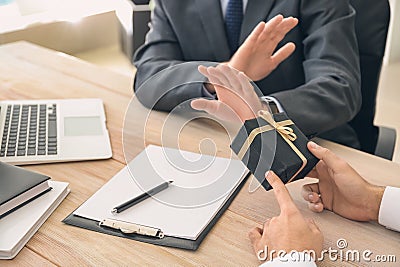 Businessman refusing to take bribe in office. Concept of corruption Stock Photo