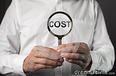 Concept of cost rising and growth, expenses through magnifier Stock Photo