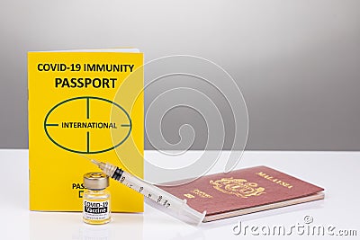 Concept of Covid-19 Immunity Passport for travel with vial and syringe Stock Photo