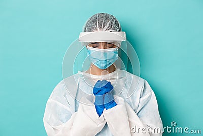 Concept of covid-19, pandemic and quarantine. Close-up of hopeful female doctor in personal protective equipment Stock Photo