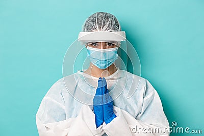 Concept of covid-19, pandemic and quarantine. Close-up of hopeful female doctor in personal protective equipment Stock Photo