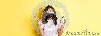 Concept of covid-19, social distancing and lifestyle. Image of excited african-american woman, wearing face mask Stock Photo