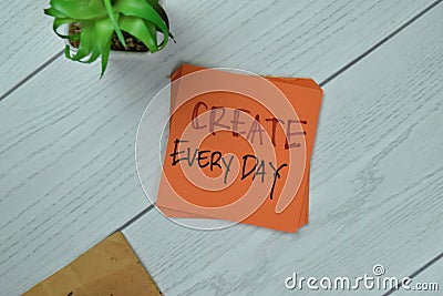 Concept of Create Every day write on sticky notes isolated on Wooden Table Stock Photo