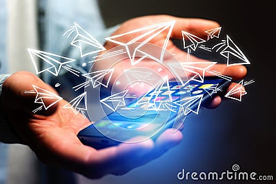 Concept of creativity with flying paper plane over a smartphone Stock Photo