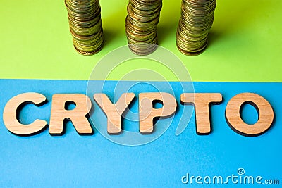 Concept of crypto and cryptocurrency coin front view. Word crypto composed of 3D letters in front of three stacks of coins, symbol Stock Photo