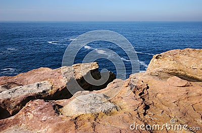 Concept of danger and risk. Waterfront lookout on cliff edge with idyllic and amazing vista of sea. Stock Photo