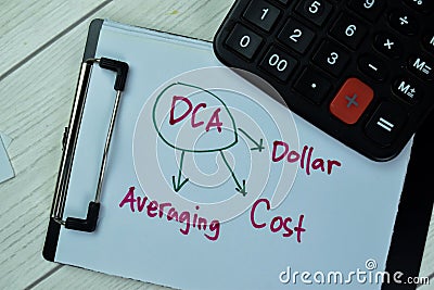 Concept of DCA - Dollar Cost Averaging write on paperwork with calculator isolated on Wooden Table Stock Photo