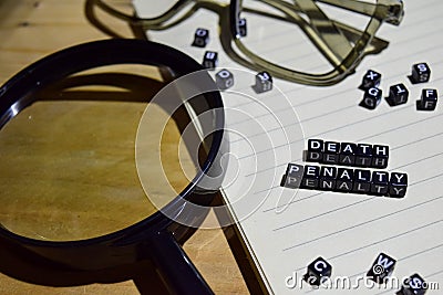 Concept of Death Penalty on wooden cubes with magnifying glass, glass eye, books in Vintage background Stock Photo