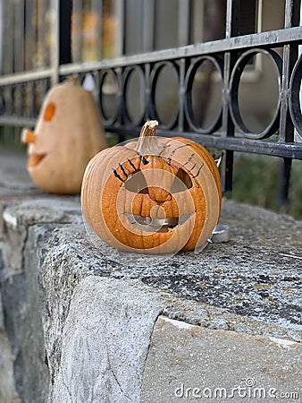 Concept of decoration for halloween. Spooky and carved jack-o-lantern pumpkin for autumn seasonal event lnear house Stock Photo