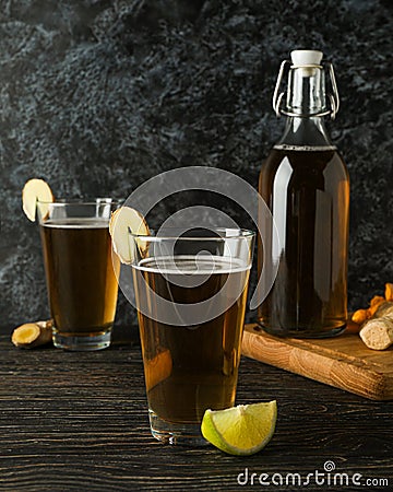 Concept of delicious drink with glasses and bottle of ginger beer on wooden table Stock Photo