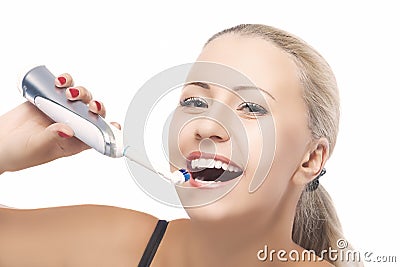 Concept of Dental Health: Blond Caucasian Woman Brushing Her Tee Stock Photo