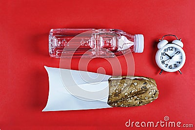 Concept diet, sandwich, water bottle, alarm clock, proper nutrition, day regimen. top view, copy space, diet, lifestyle, Stock Photo