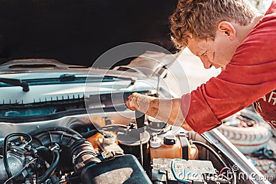 The concept of disability of people and their adaptation to life.Disabled c screwdriver in the hands of repairing the engine. Stock Photo