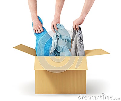 The concept of donation. Hands take out clothes from a cardboard box Stock Photo