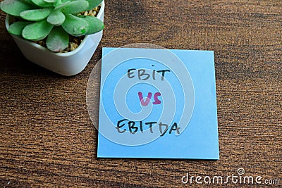 Concept of Ebit vs Ebitda write on sticky notes isolated on Wooden Table Stock Photo