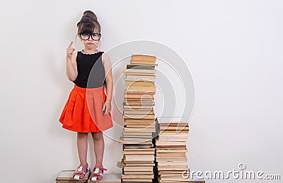 Concept of education and reading. Industrious child. Little Girl reading the book. Stock Photo